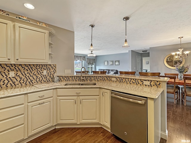 kitchen with dishwasher, cream cabinets, dark wood-type flooring, and a sink