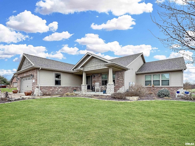 craftsman-style home featuring a front yard, brick siding, and a garage