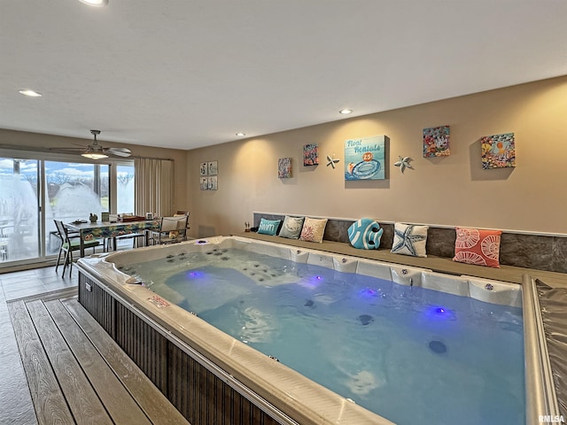 interior space featuring a jacuzzi, recessed lighting, and wood finished floors