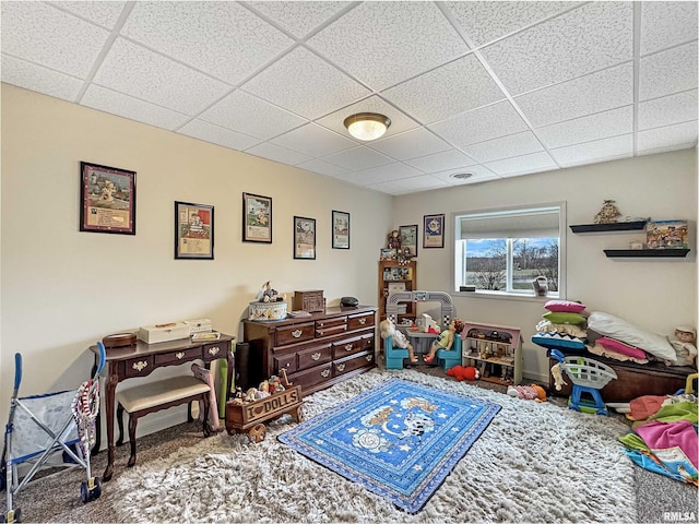 game room with a paneled ceiling