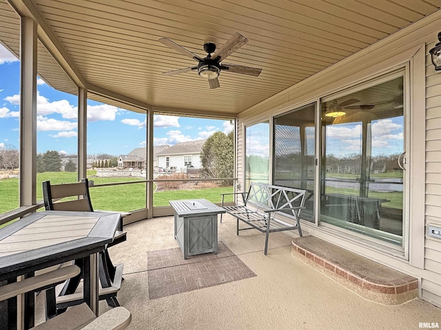 sunroom / solarium with wooden ceiling and a ceiling fan