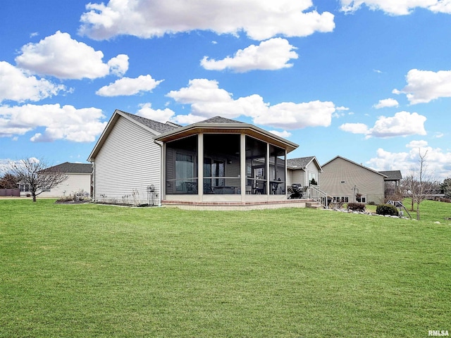 rear view of property with a lawn and a sunroom