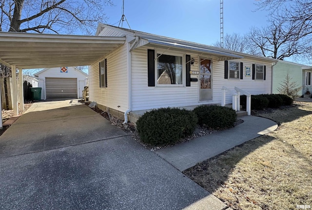 view of front of house with an outbuilding, driveway, fence, and a garage