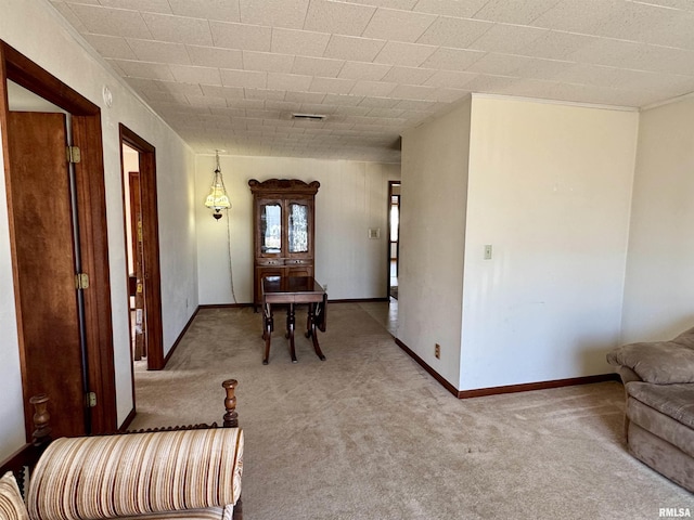 entryway featuring carpet floors, visible vents, and baseboards