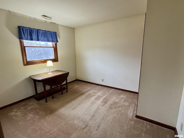 carpeted empty room featuring baseboards and visible vents