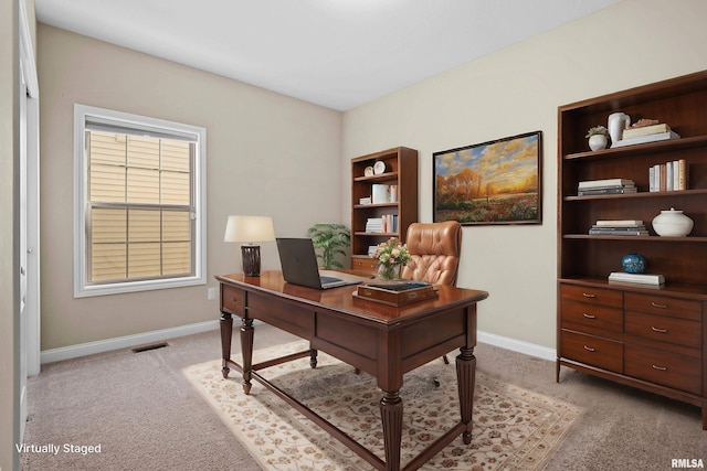 home office with light colored carpet, visible vents, and baseboards