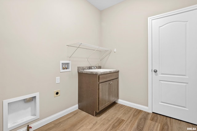 laundry area with a sink, light wood finished floors, washer hookup, and electric dryer hookup