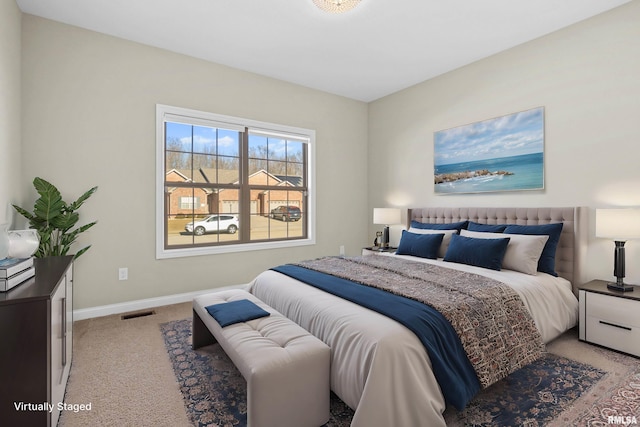 bedroom featuring light carpet, visible vents, and baseboards