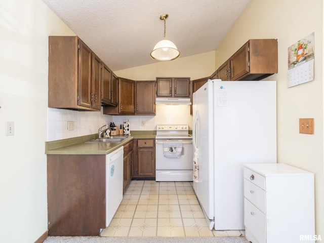 kitchen with white appliances, decorative backsplash, vaulted ceiling, under cabinet range hood, and a sink