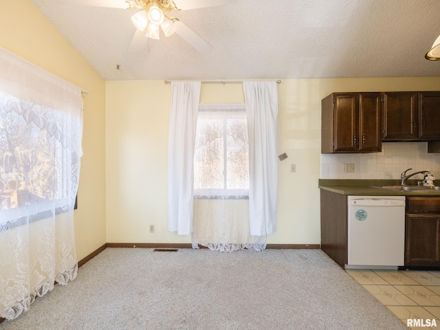 kitchen with visible vents, decorative backsplash, white dishwasher, dark brown cabinets, and a sink