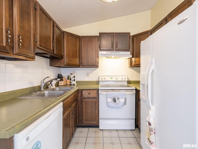 kitchen with lofted ceiling, a sink, a textured ceiling, white appliances, and under cabinet range hood