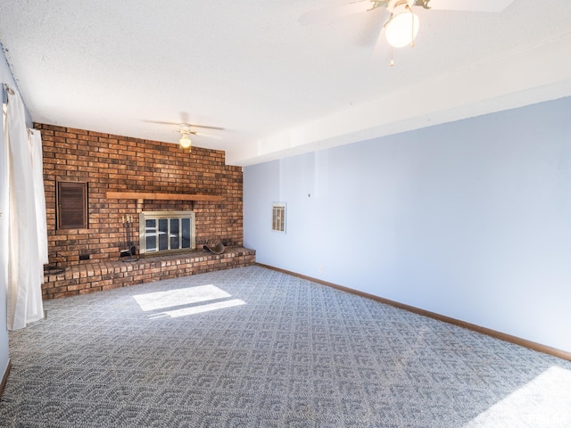 unfurnished living room with carpet, a fireplace, a textured ceiling, and ceiling fan