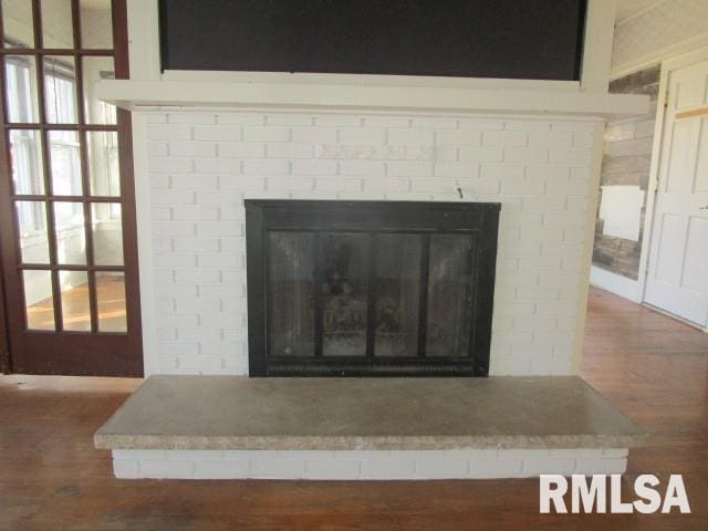 room details featuring a fireplace and wood finished floors