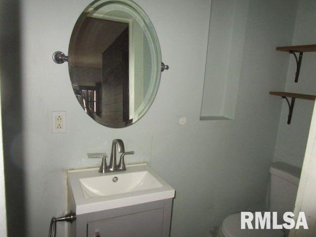 half bath with vanity and toilet