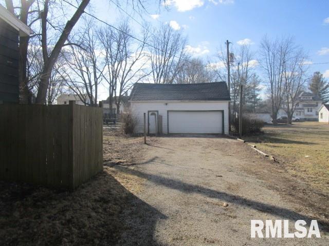 garage with driveway and fence