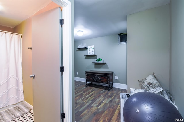 interior space featuring baseboards and wood finished floors