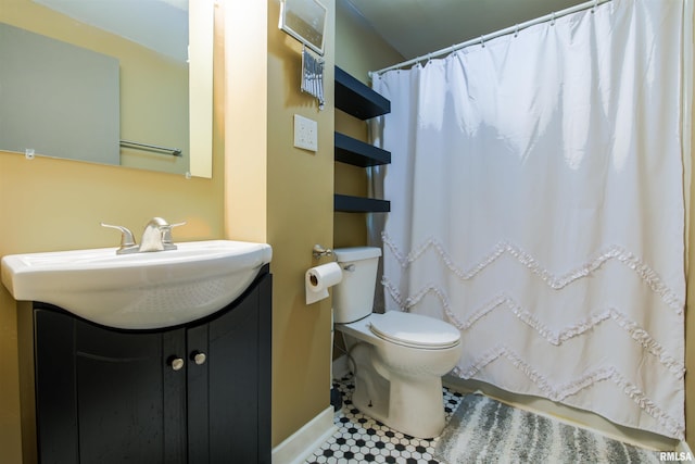 bathroom featuring toilet, curtained shower, and vanity