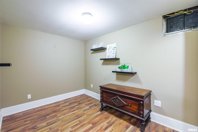 interior space featuring wood finished floors and baseboards