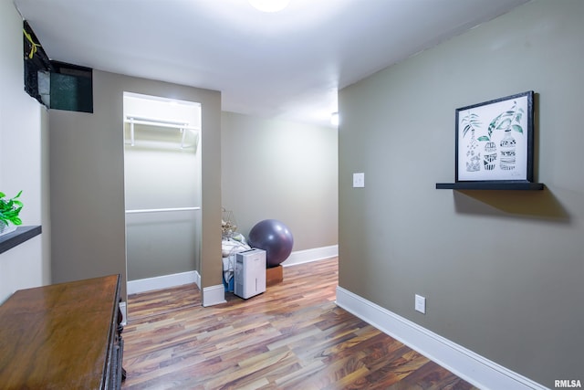 interior space with wood finished floors and baseboards