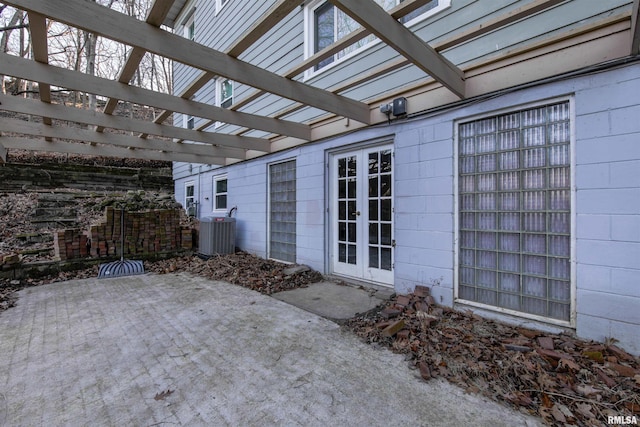 view of patio with central AC unit, a pergola, and french doors