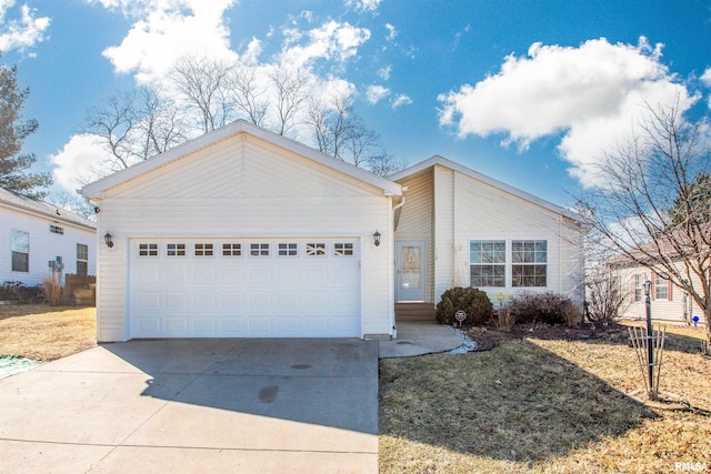 view of front of home with concrete driveway and an attached garage