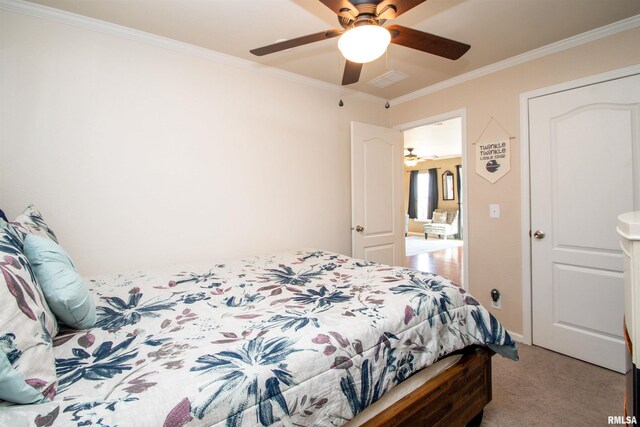 carpeted bedroom with baseboards, a ceiling fan, and crown molding