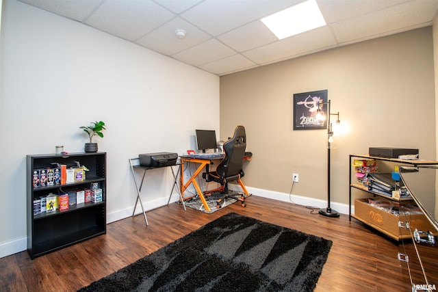 office space featuring a drop ceiling, wood finished floors, and baseboards