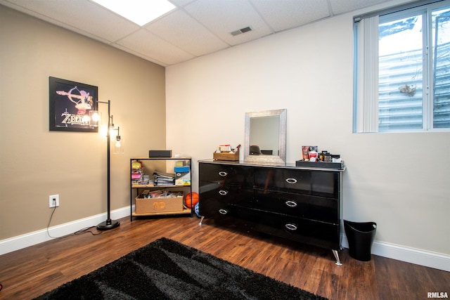 miscellaneous room with dark wood-style floors, a paneled ceiling, visible vents, and baseboards