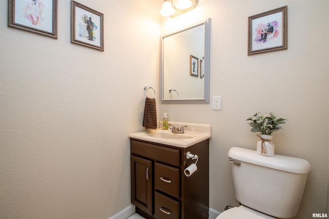 bathroom featuring toilet and vanity