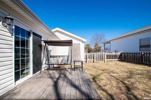 wooden deck featuring fence and a yard