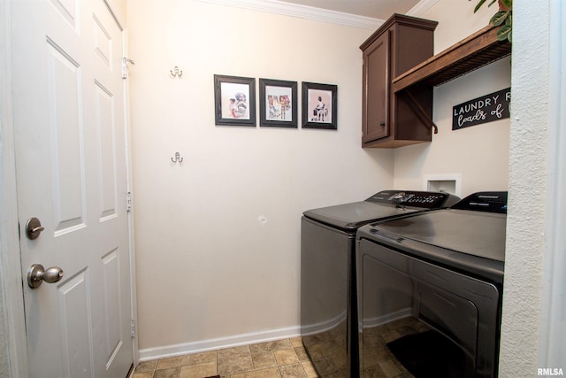 laundry room featuring cabinet space, baseboards, separate washer and dryer, and crown molding