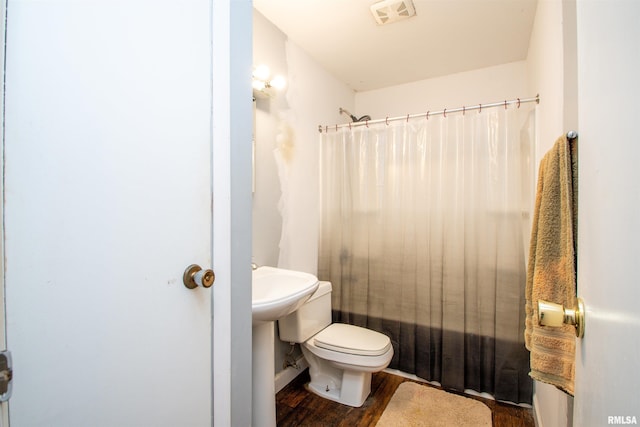 bathroom with shower / tub combo, visible vents, toilet, and wood finished floors