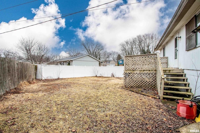 view of yard with stairs, a fenced backyard, and a wooden deck