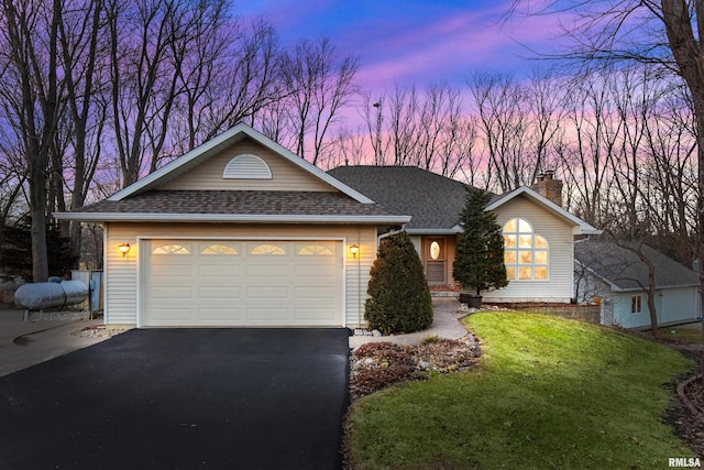 single story home featuring a lawn, driveway, roof with shingles, a garage, and a chimney