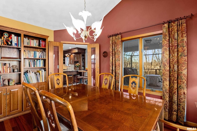 dining area featuring an inviting chandelier and dark wood finished floors