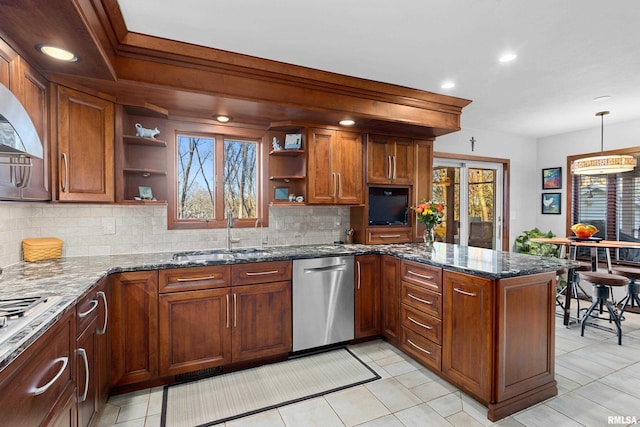 kitchen featuring open shelves, a peninsula, stainless steel dishwasher, brown cabinetry, and a sink