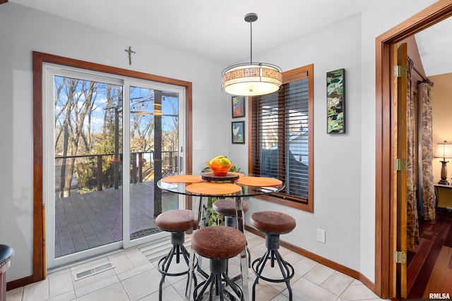 dining room featuring baseboards and visible vents