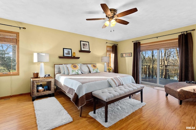 bedroom with light wood-style flooring, ceiling fan, baseboards, and access to outside