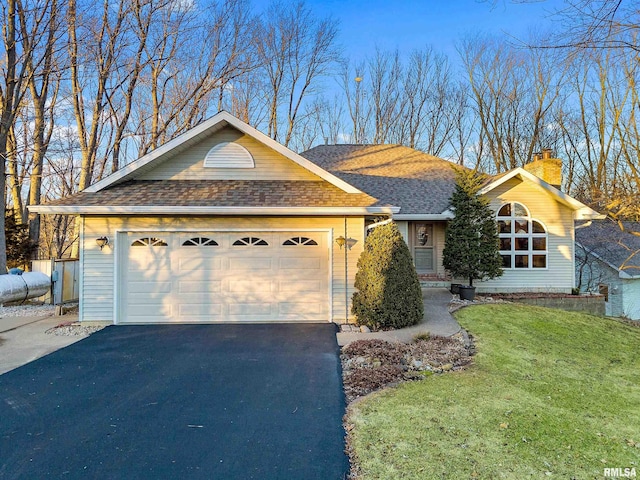 view of front of home with a shingled roof, a chimney, a front lawn, a garage, and aphalt driveway