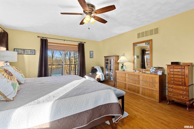 bedroom featuring visible vents, ceiling fan, and wood finished floors