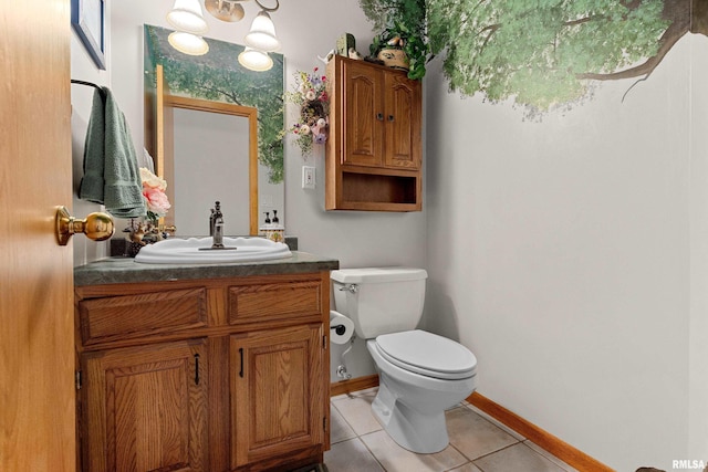 bathroom with tile patterned floors, baseboards, toilet, and vanity