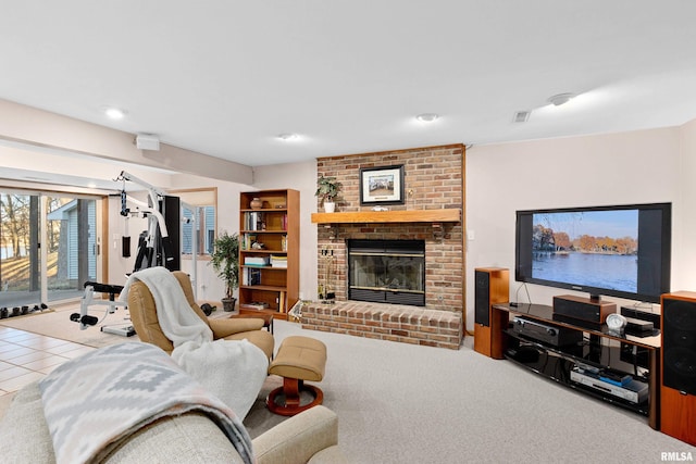 living area featuring tile patterned floors, visible vents, and a fireplace