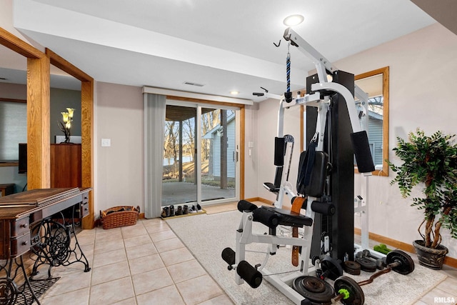 workout area with light tile patterned floors, visible vents, and baseboards