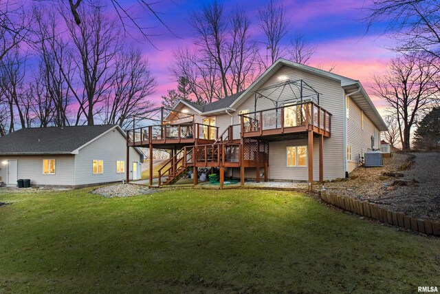 rear view of property featuring stairway, central air condition unit, a yard, and a deck