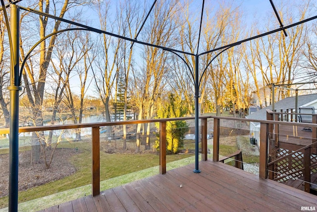 deck with a lawn and a water view