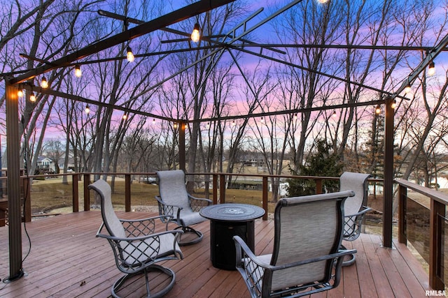 wooden terrace featuring an outdoor fire pit