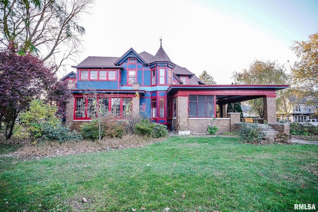 victorian-style house with a front lawn