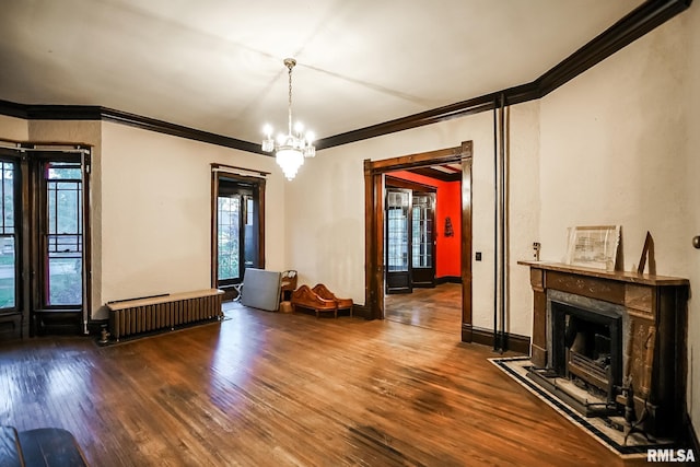 unfurnished living room featuring ornamental molding, radiator, a fireplace, and wood-type flooring