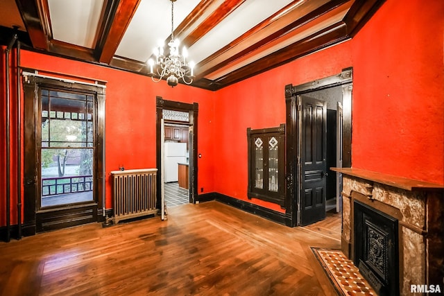 interior space featuring beam ceiling, a notable chandelier, baseboards, and wood finished floors