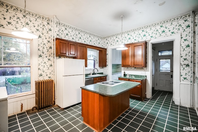 kitchen with radiator, wallpapered walls, freestanding refrigerator, a sink, and dishwasher